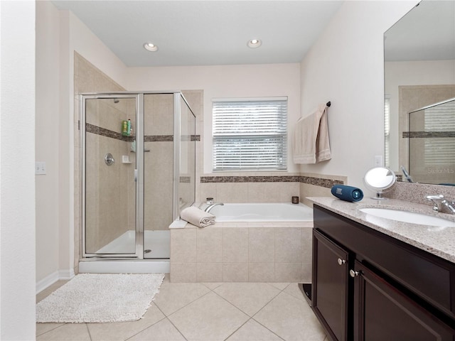 bathroom featuring vanity, independent shower and bath, and tile patterned flooring