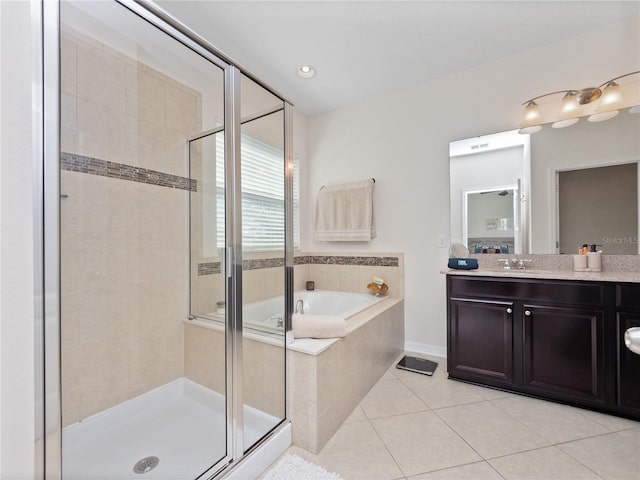 bathroom with independent shower and bath, tile patterned flooring, and vanity