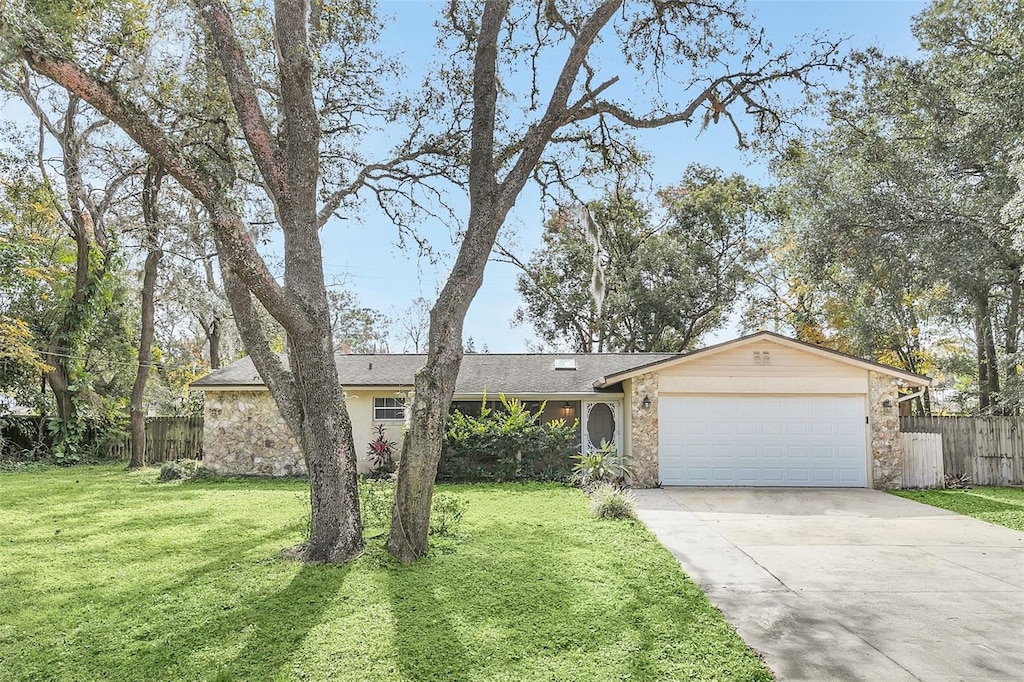 single story home with a garage and a front yard