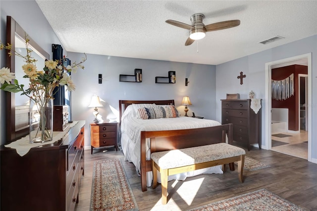 bedroom with wood-type flooring, a textured ceiling, and ceiling fan