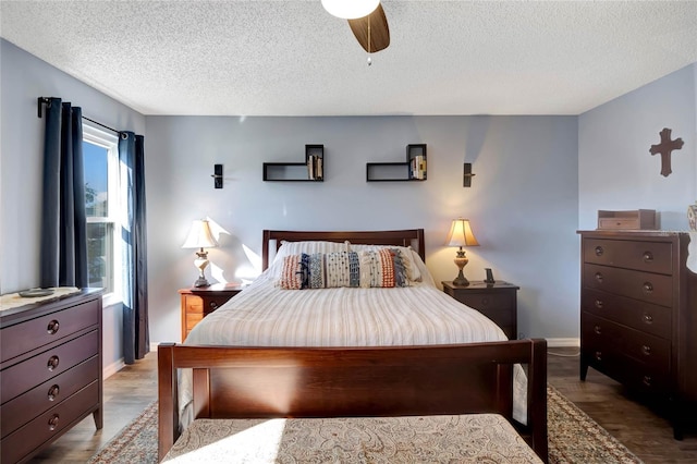 bedroom with a textured ceiling, ceiling fan, and light hardwood / wood-style floors