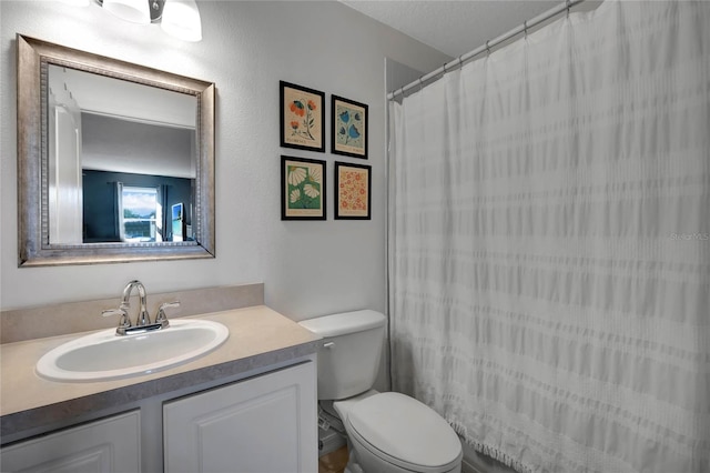 bathroom with vanity, walk in shower, and toilet