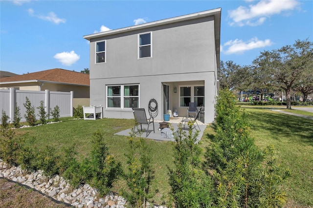 back of property featuring a yard and a patio