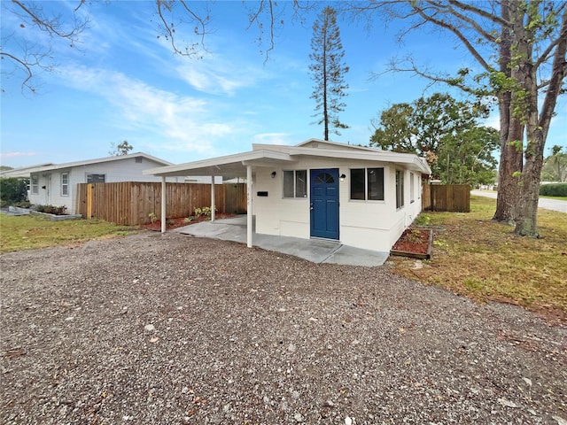 ranch-style home featuring a carport