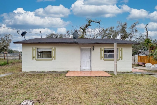 rear view of property with a yard