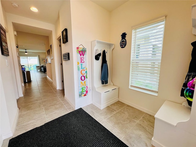 mudroom featuring light tile patterned floors and ceiling fan