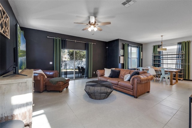 living room featuring ceiling fan and light tile patterned flooring