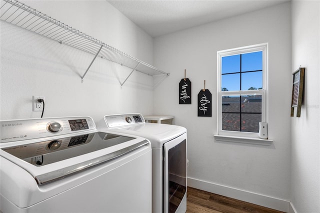 washroom featuring washing machine and clothes dryer and dark hardwood / wood-style floors