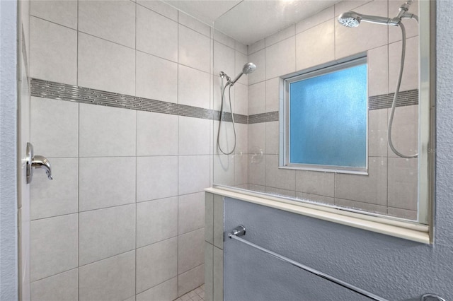 bathroom with a tile shower