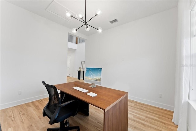 office area with a chandelier and light hardwood / wood-style flooring