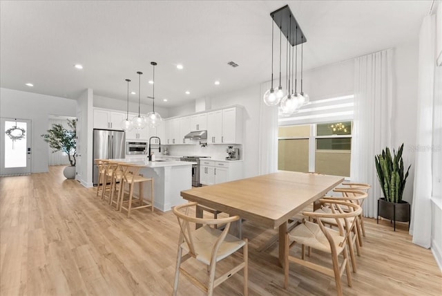 dining room featuring light hardwood / wood-style floors and sink