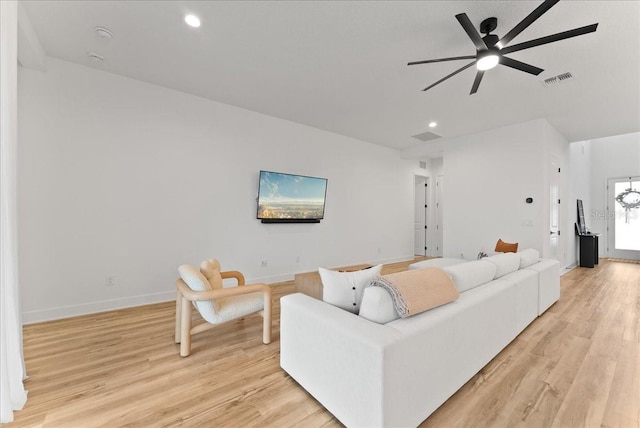 living room with light wood-type flooring and ceiling fan