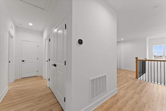 hallway with light hardwood / wood-style floors