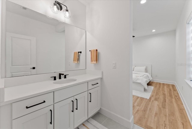 bathroom with hardwood / wood-style floors and vanity