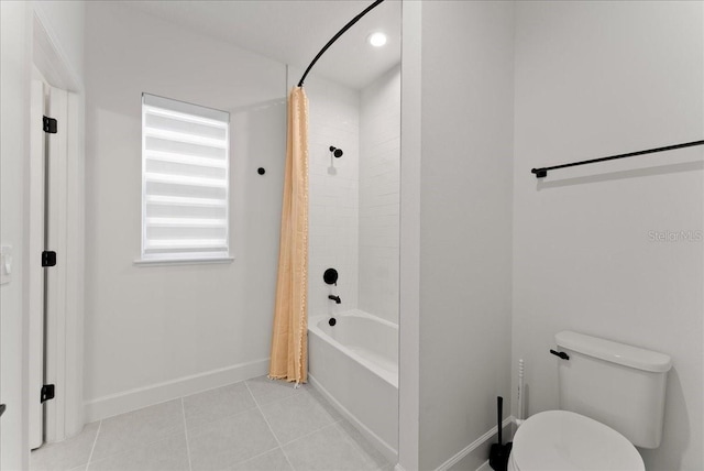 bathroom with tile patterned floors, toilet, and shower / tub combo