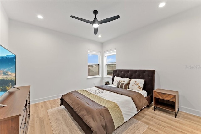 bedroom with ceiling fan and light hardwood / wood-style floors