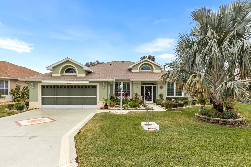 ranch-style home featuring a garage and a front yard