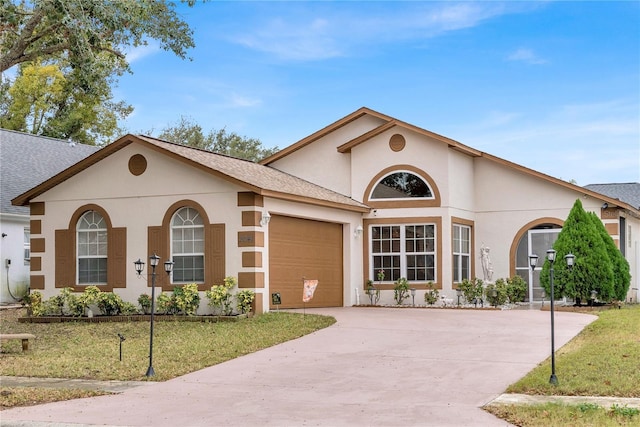 view of front facade featuring a garage and a front lawn