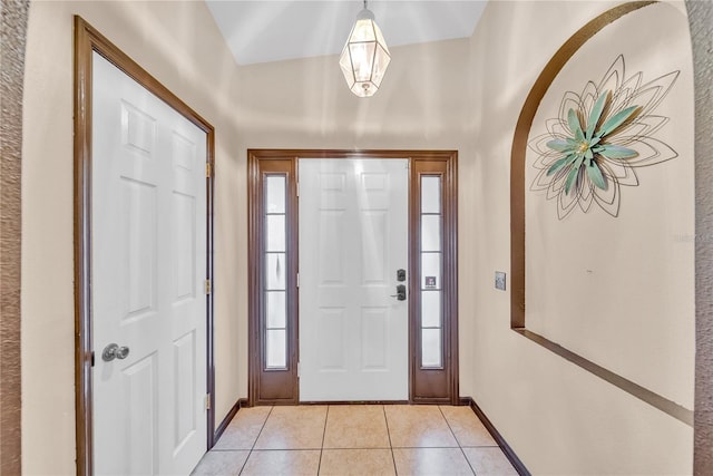 tiled entrance foyer with a healthy amount of sunlight