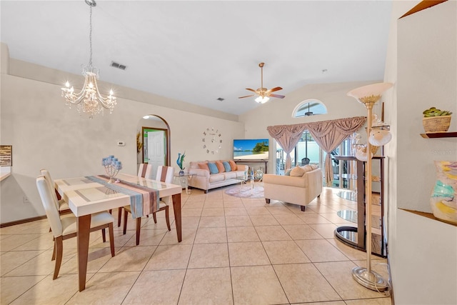 interior space featuring ceiling fan with notable chandelier, vaulted ceiling, and light tile patterned flooring