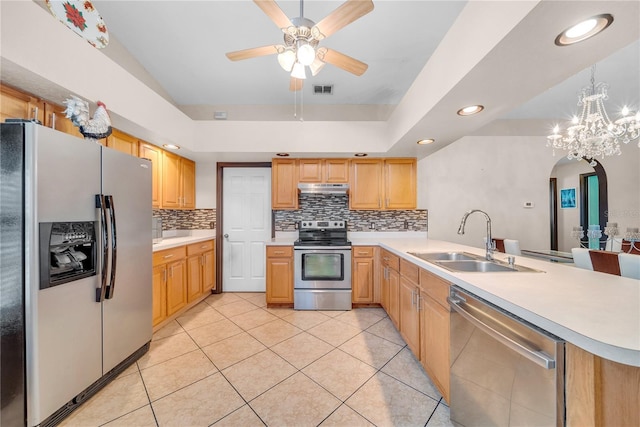 kitchen with sink, light tile patterned floors, stainless steel appliances, and hanging light fixtures