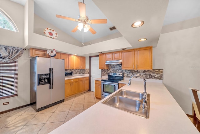 kitchen featuring high vaulted ceiling, tasteful backsplash, sink, light tile patterned floors, and stainless steel appliances