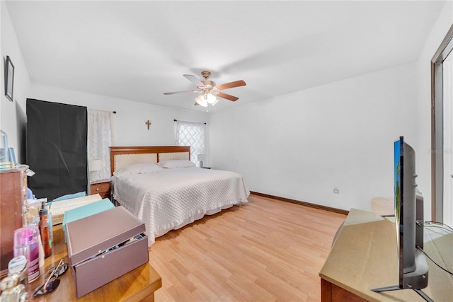 bedroom with hardwood / wood-style floors and ceiling fan