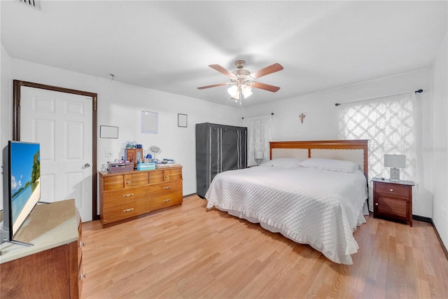 bedroom with ceiling fan and light hardwood / wood-style floors