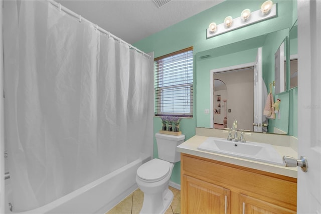 full bathroom featuring tile patterned floors, toilet, a textured ceiling, vanity, and shower / bath combo