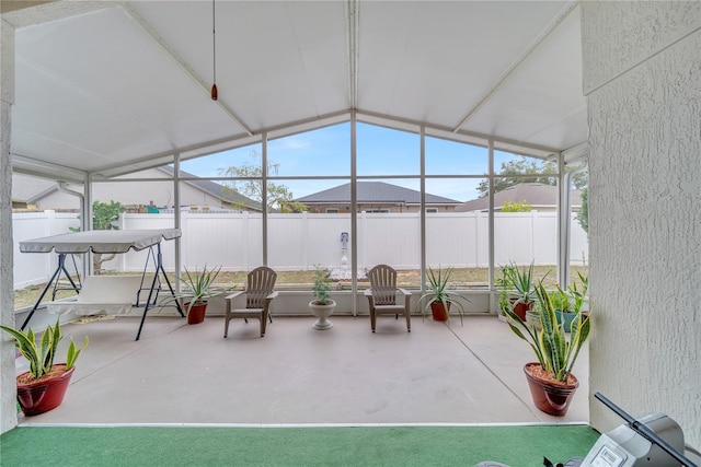 sunroom featuring lofted ceiling