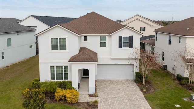 view of front property featuring a garage and a front yard