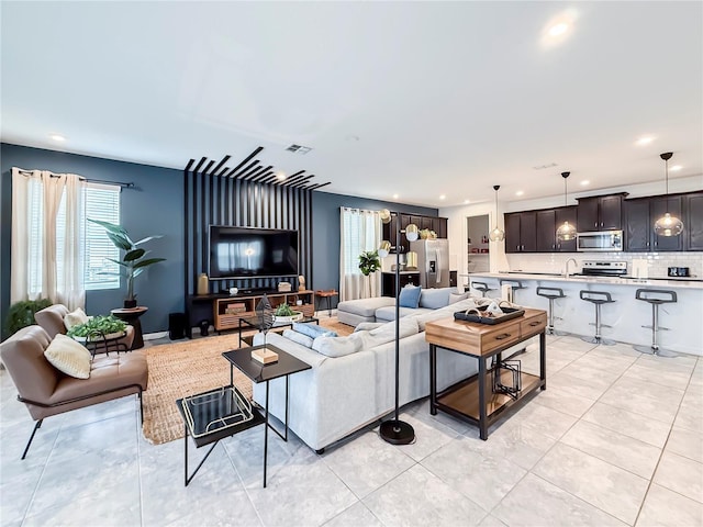 tiled living room featuring sink