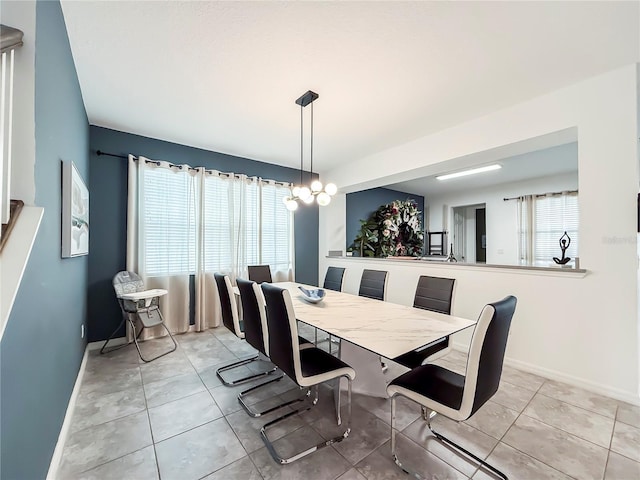 dining room with a notable chandelier and light tile patterned floors