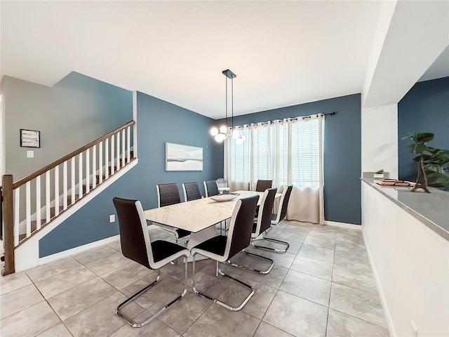 dining space featuring light tile patterned floors and a notable chandelier