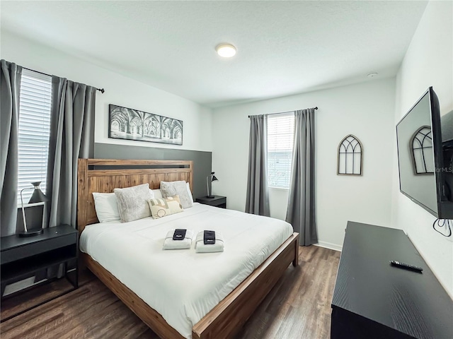 bedroom with dark hardwood / wood-style floors