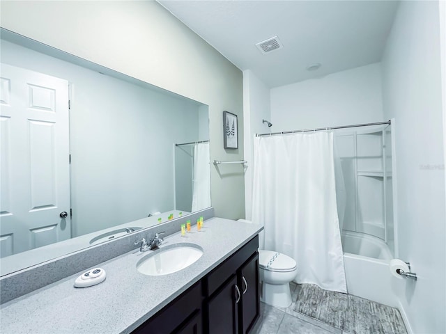 full bathroom featuring shower / bath combo with shower curtain, tile patterned floors, vanity, and toilet