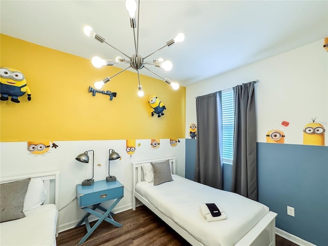 bedroom with dark hardwood / wood-style floors and a notable chandelier