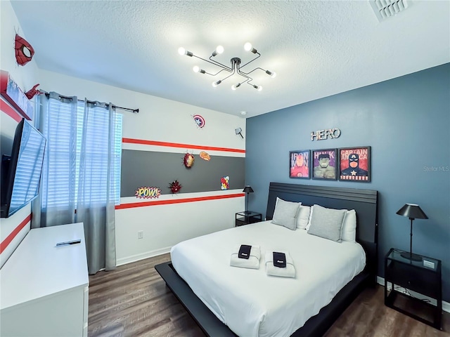 bedroom with dark wood-type flooring and a textured ceiling