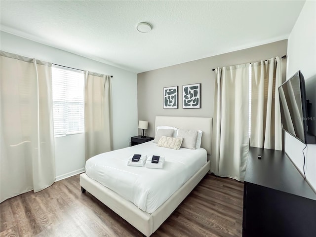 bedroom featuring a textured ceiling and wood-type flooring