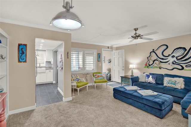 carpeted living room featuring sink, ceiling fan, and ornamental molding