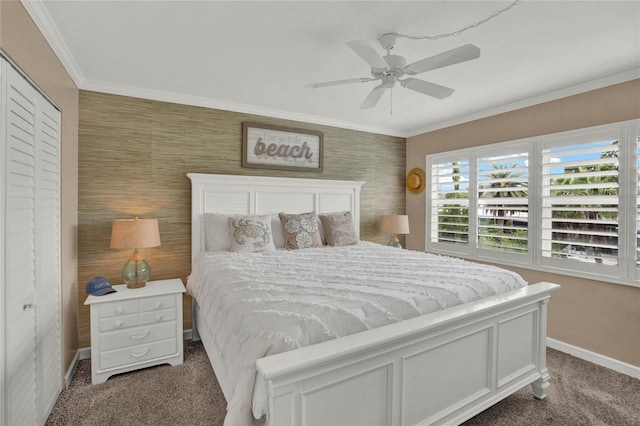 bedroom with ceiling fan, dark carpet, a closet, and crown molding