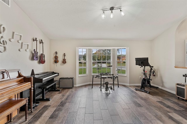 interior space with a textured ceiling and dark hardwood / wood-style flooring