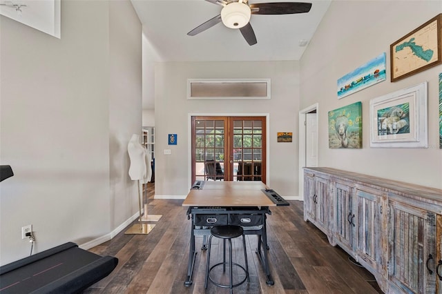 dining room featuring ceiling fan, french doors, a high ceiling, and dark wood-type flooring