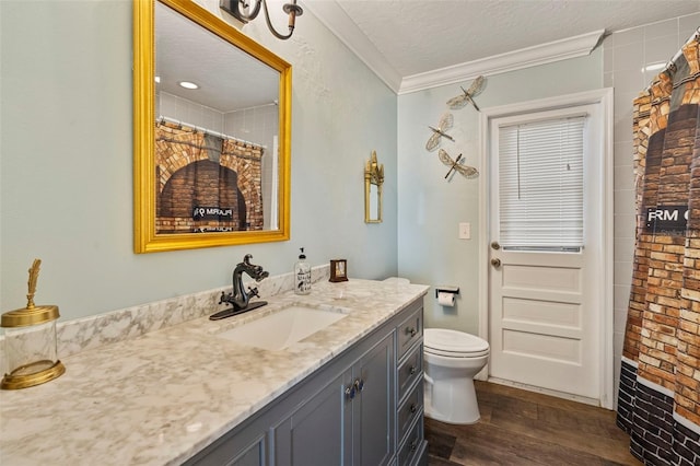 bathroom featuring crown molding, toilet, a textured ceiling, walk in shower, and vanity