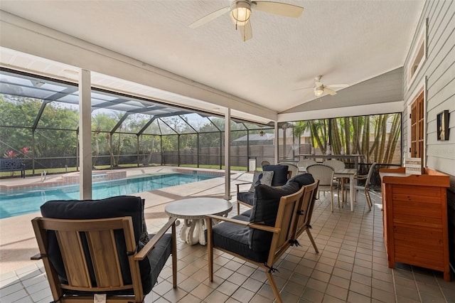 view of pool featuring ceiling fan, an outdoor bar, a lanai, and a patio area