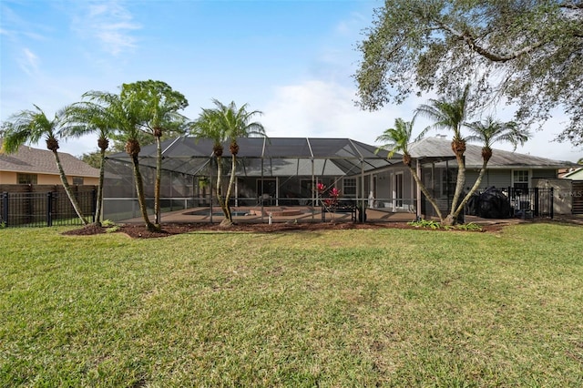 view of yard featuring glass enclosure, a swimming pool, and a patio