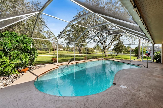 view of swimming pool featuring a patio area, a lanai, and a yard