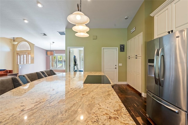 kitchen featuring white cabinets, stainless steel refrigerator with ice dispenser, decorative light fixtures, dark wood-type flooring, and light stone counters