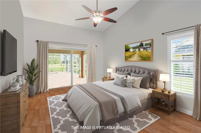 bedroom with access to exterior, ceiling fan, light hardwood / wood-style floors, and lofted ceiling