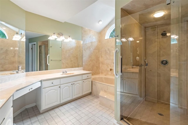 bathroom featuring a tub to relax in, tile patterned floors, lofted ceiling, and vanity